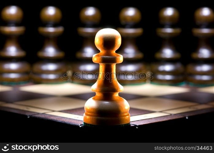 It is a lot of chessmen on a chess board. (are located it is horizontal). A black background.