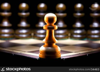 It is a lot of chessmen on a chess board. (are located it is horizontal). A black background.