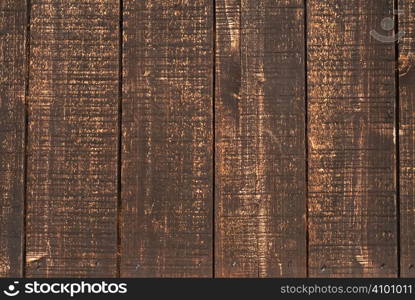 It is an old and brown wood wall.