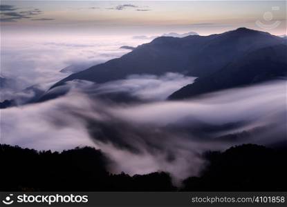 It is beautiful mountain landscape full of clouds.
