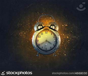 It is high time to wake up. Alarm clock in fire flames on black background