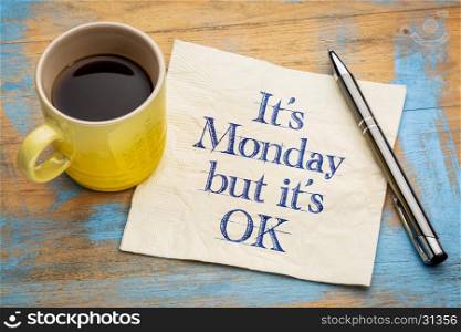 It is Monday, but it's OK - handwriting on a napkin with a cup of espresso coffee