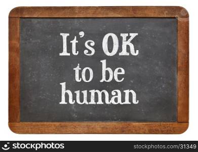 It is OK to be human - white chalk text on a vintage slate blackboard