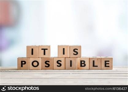 It is possible sign made of wooden cubes on a table