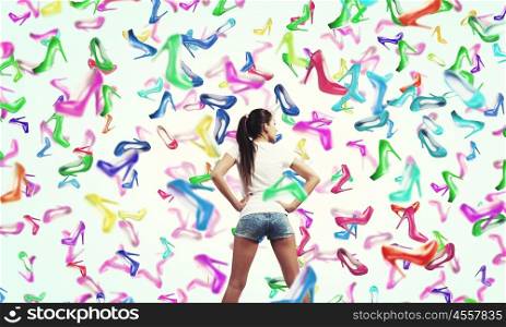 It is rainning shoes. Beautiful young woman in shorts and falling shoes