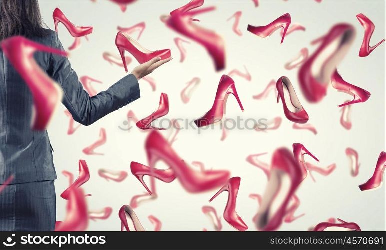 It is rainning shoes. Beautiful young woman in suit and falling shoes