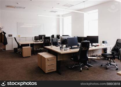 IT open space office. Computer Work Stations. Office Workplace with windows.. Modern Office Space Interior.