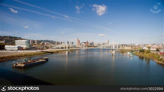 It&rsquo;s a clear day in Portland Oregon at Tilikum Crossing as people traverse the river