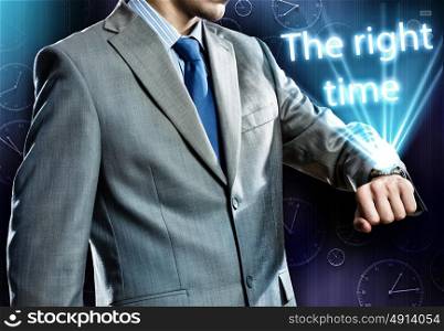 It&rsquo;s time to act. Close up of businessman looking at watch at his wrist