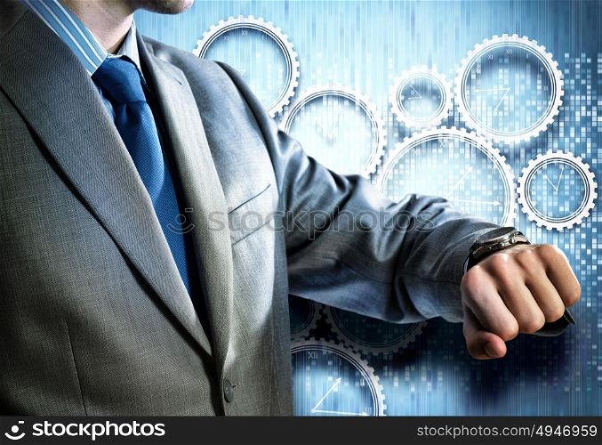 It&rsquo;s time to act. Close up of businessman looking at watch at his wrist