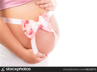 It's a girl, body part of pregnant woman isolated on white background, big tummy with pink bow on it, great gift for loving family