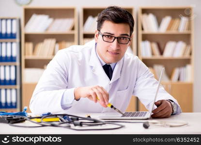 IT technician repairing broken laptop notebook computer