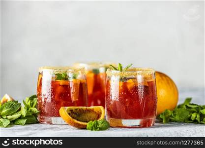 Italian aperol spritz cocktail with orange slices and ingredients on light gray stone table. Summer drink, homemade sangria, Cocktail of sweet. Copy space