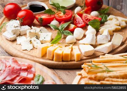 Italian appetizer - various types of ham, cheese and grissini