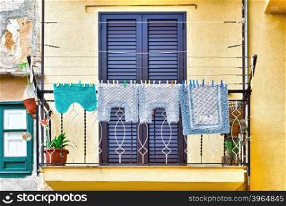 Italian Balcony in Palermo with Closed Wooden Shutters, Decorated with Mats