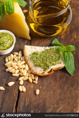 Italian basil pesto bruschetta ingredients over old wood macro