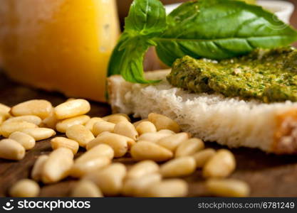 Italian basil pesto bruschetta ingredients over old wood macro