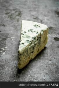 Italian blue cheese. On the stone table.. Italian blue cheese.