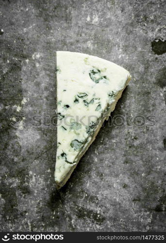 Italian blue cheese. On the stone table.. Italian blue cheese.