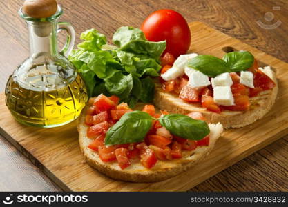 italian bruschetta with fresh tomatoes, basil, garlic, olive oil and cheese