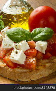 italian bruschetta with fresh tomatoes, basil, garlic, olive oil and cheese