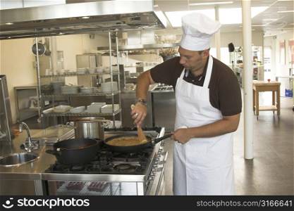 Italian checking stirring in his pasta sauce