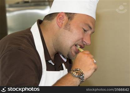 Italian chef checking if his pasta is al dente