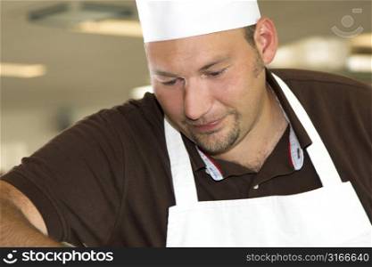 Italian chef working in the restaurant kitchen concentrating on his work