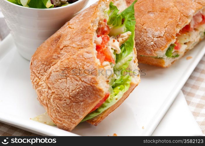 italian ciabatta panini sandwich with chicken and tomato