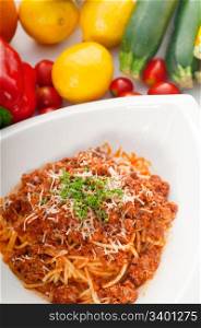 Italian classic spaghetti with bolognese sauce and fresh vegetables on background,MORE DELICIOUS FOOD ON PORTFOLIO