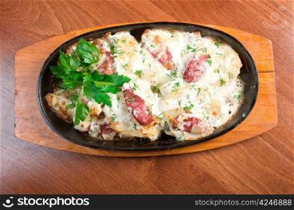 Italian cuisine.Fried eggs with sausage on pan