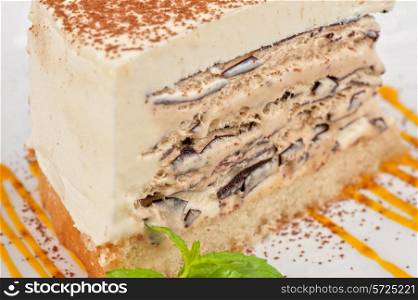 Italian dessert. Cake from ice cream mascarpone cheese chocolate. Decorated with mango sauce.
