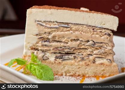 Italian dessert. Cake from ice cream mascarpone cheese chocolate. Decorated with mango sauce.. chocolate cake with jam ice cream