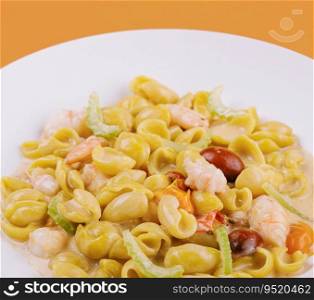 Italian dish macarana with shrimp on yellow background