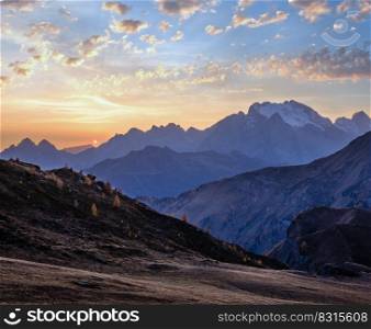 Italian Dolomites mountain peaceful hazy evening dusk view from Giau Pass. Climate, environment and travel concept scene.