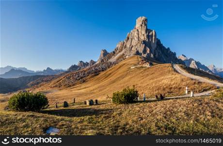 Italian Dolomites mountain (Ra Gusela rock in front) peaceful sunny evening view from Giau Pass. Picturesque climate, environment and travel concept scene. People unrecognizable.
