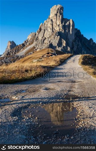 Italian Dolomites mountain (Ra Gusela rock in front) peaceful sunny evening view from Giau Pass. People unrecognizable. Picturesque climate, environment and travel concept scene.