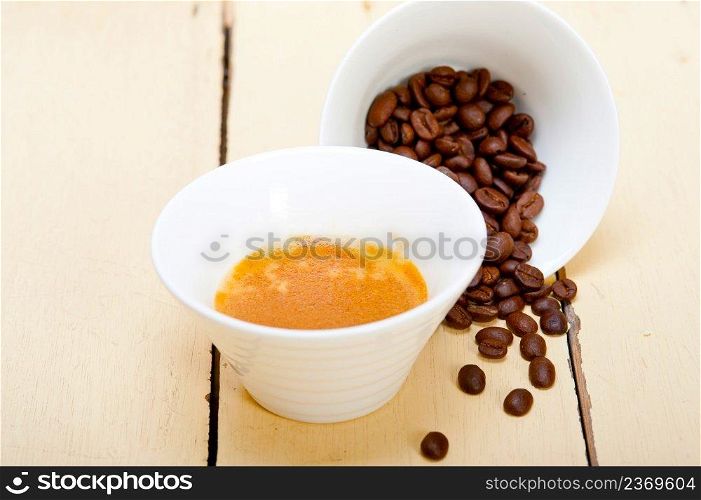 italian espresso cofee and beans on a white wood table 
