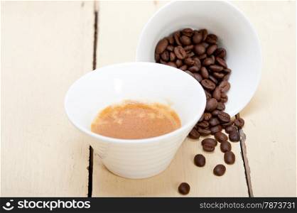 italian espresso cofee and beans on a white wood table