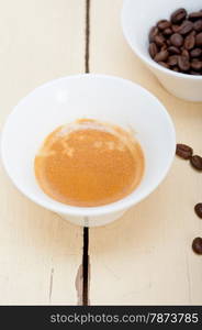 italian espresso cofee and beans on a white wood table