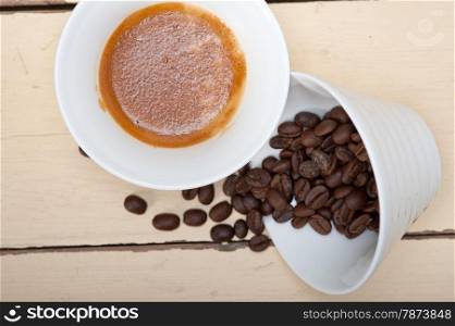 italian espresso cofee and beans on a white wood table