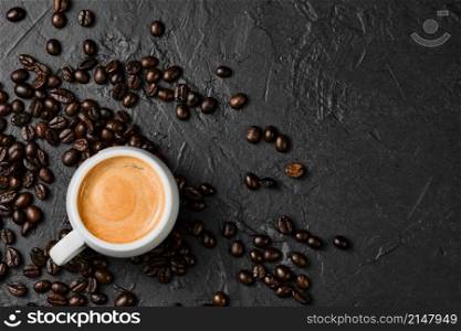 Italian espresso in a white cup. Coffee for breakfast. Cup of fresh coffee on vintage black table, top view, flat lay.