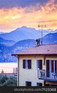 Italian evening scenery: House and mountain range, colorful sky
