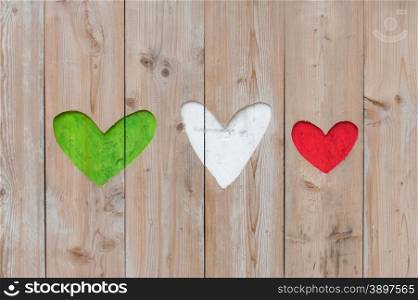 Italian flag colors carved into wooden love hearts