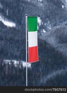 Italian flag waving by wind on pole at ski resort