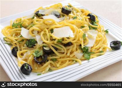 Italian Jewish cold pasta, or egg noodles, served tossed in chopped garlic, parsley, sliced olives and olive oill topped with parmasan. The dish is served on the Jewish sabbath, when cooking is prohibited.