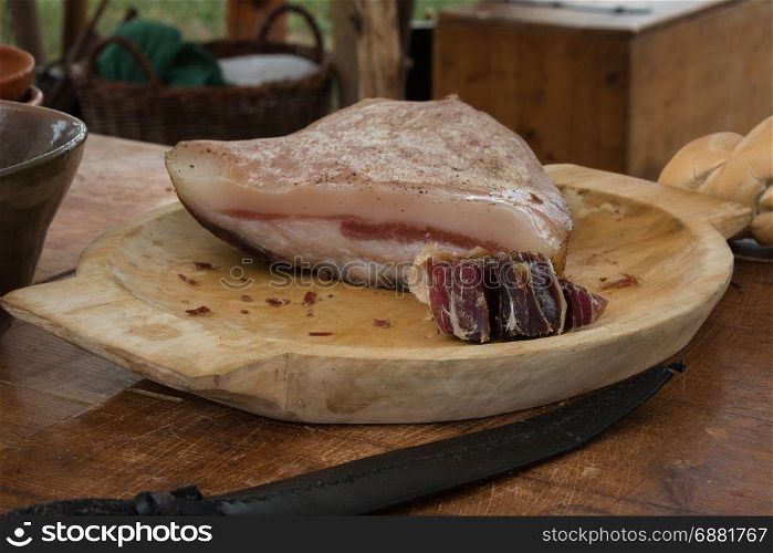 Italian Lard in Wooden Plate on Brown Table