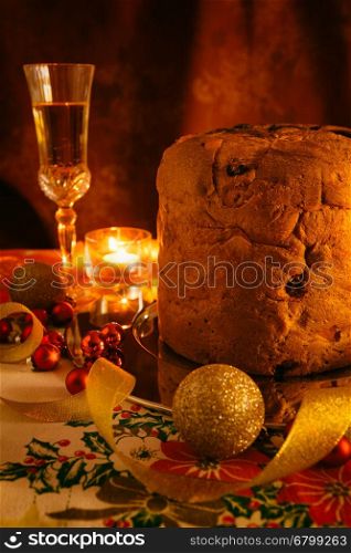 Italian panettone and sparkling wine with Christmas decorations. Italian panettone and sparkling wine