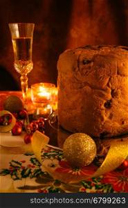 Italian panettone and sparkling wine with Christmas decorations. Italian panettone and sparkling wine