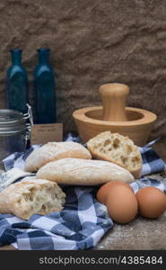Italian panini rolls in rustic kitchen setting with cooking utensils
